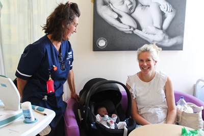 Midwife with new mother and baby