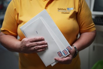 Volunteer holding messages for patients